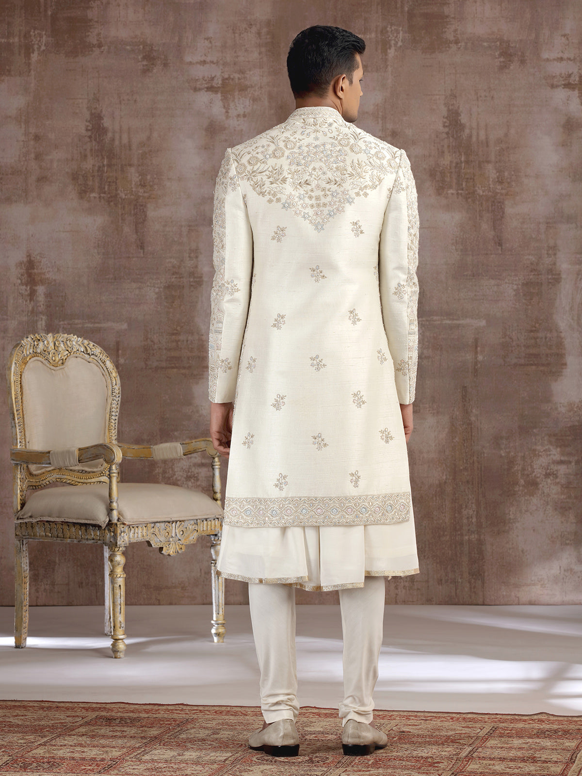 Cream silk peshwai sherwani with heavy embellishments