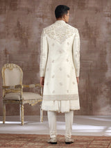 Cream silk peshwai sherwani with heavy embellishments