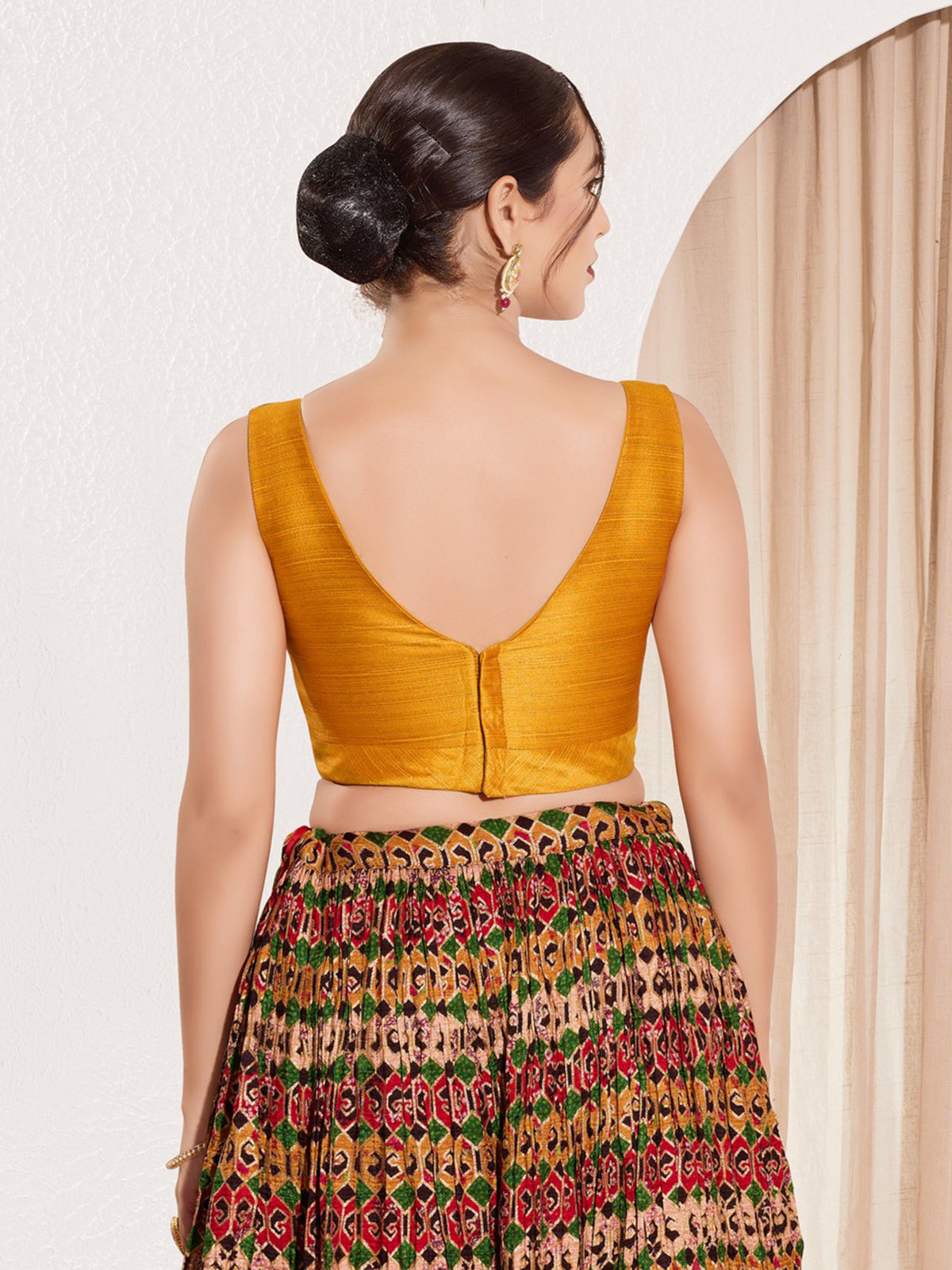 Mustard yellow silk u neck sleeveless festive blouse
