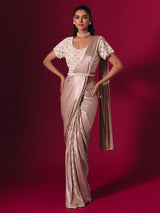 Pastel peach shimmer saree with elegant pearl embellishments