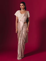 Pastel peach shimmer saree with elegant pearl embellishments