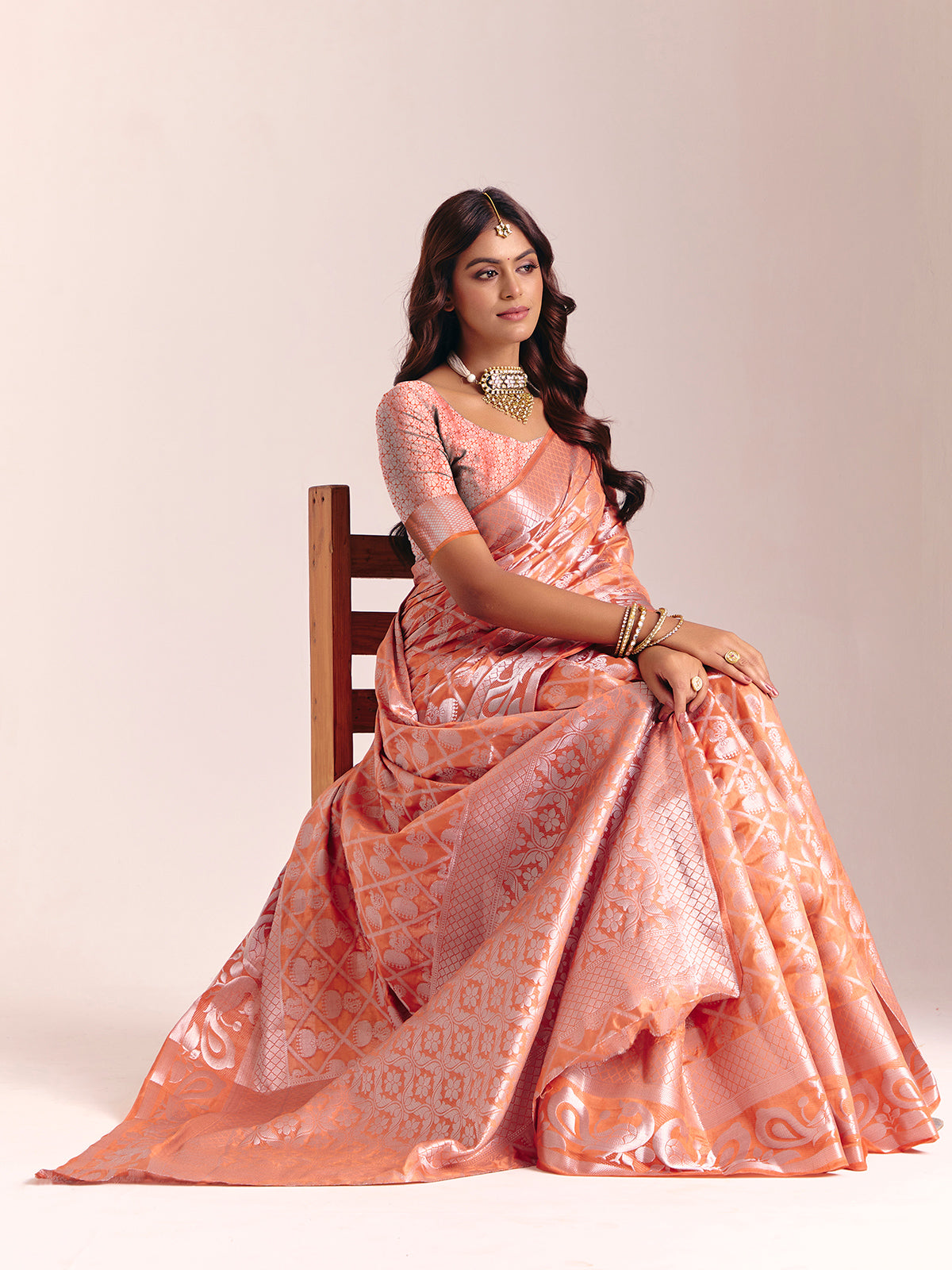 Peach silk saree accented with classic zari work