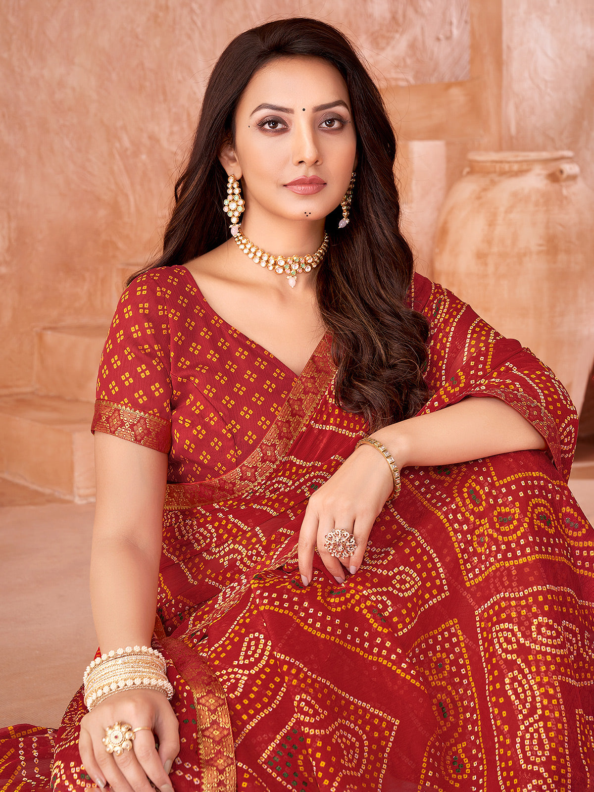 Red bandhani printed chiffon saree for festive wear