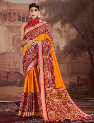 Classy apricot orange patola silk saree for wedding events